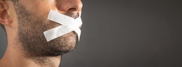 Caucasian man with tape on mouth Censorship