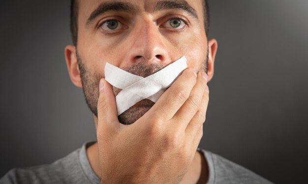 Caucasian Man With Tape On Mouth Censorship