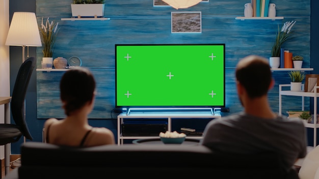 caucasian man and woman looking at green screen