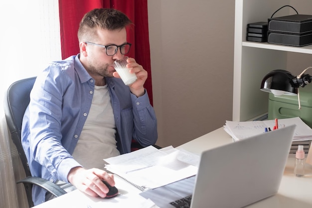 Caucasian man working at home on laptop computer