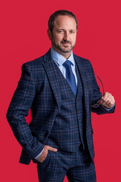 Caucasian mature man in business suit isolated on red background business man wear suit