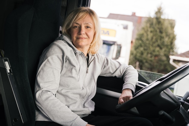Кавказская женщина средних лет за рулем грузовика дальнобойщик работница транспортной отрасли
