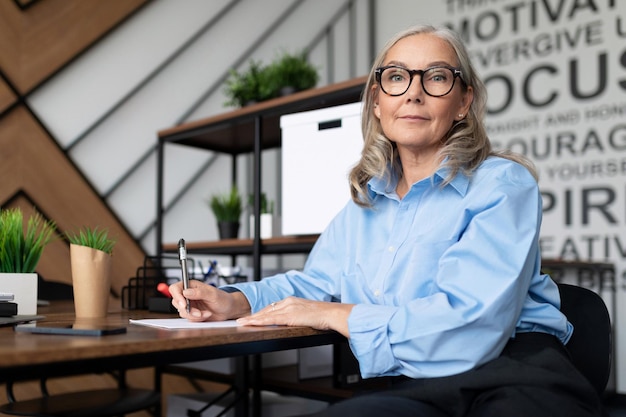 Caucasian middle aged older businesswoman in office workplace