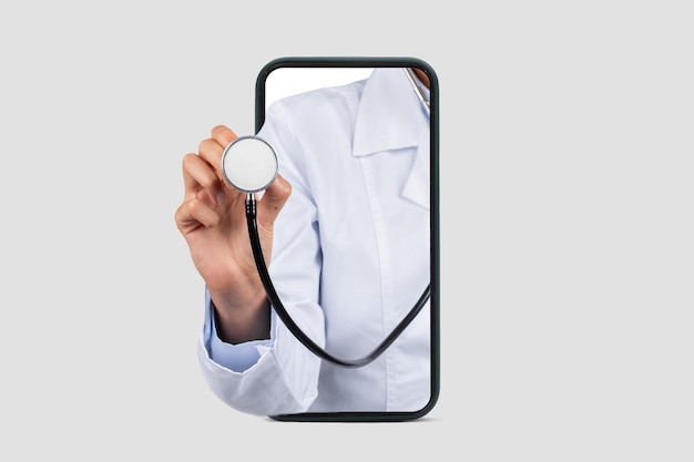 Photo caucasian millennial doctor in white coat listen breathe with stethoscope on big phone screen