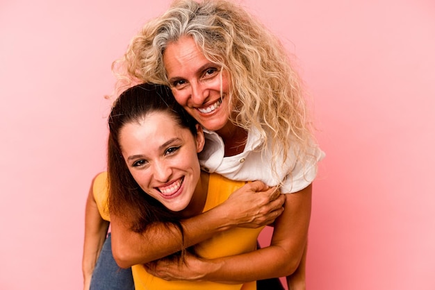 Caucasian mom and daughter isolated on pink background