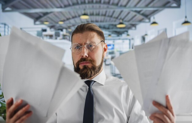 Caucasian office worker with stack of