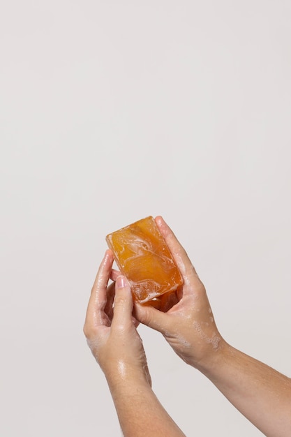 Caucasian person washing hands with soap