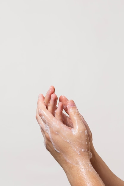 Caucasian person washing hands with soap