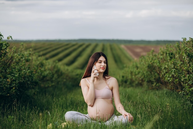 Caucasian pregnant woman talking on the smart phone