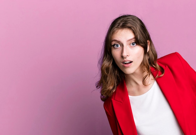 Caucasian pretty blonde womanwearing a red blazer businesswoman concept