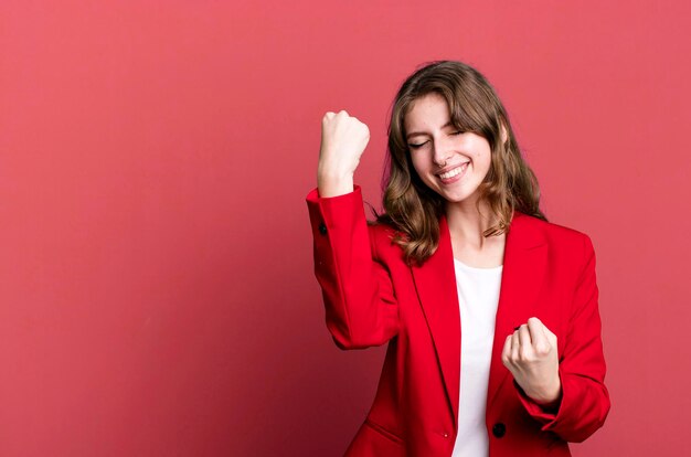 Foto donna bionda graziosa caucasica che indossa un concetto della donna di affari del blazer rosso