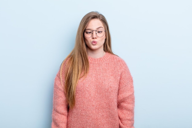 caucasian red hair woman looking goofy and funny with a silly cross-eyed expression, joking and fooling around