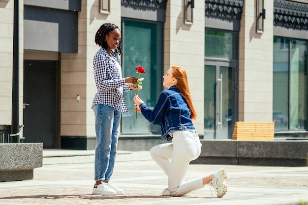 Caucasian redhaired ginger woman ask her brazilian girlfriend to be her wife