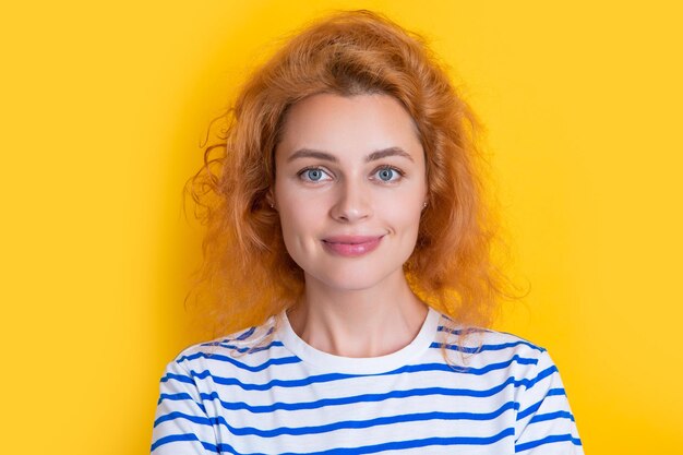 Caucasian redhead woman face isolated on yellow background face of young redhead woman