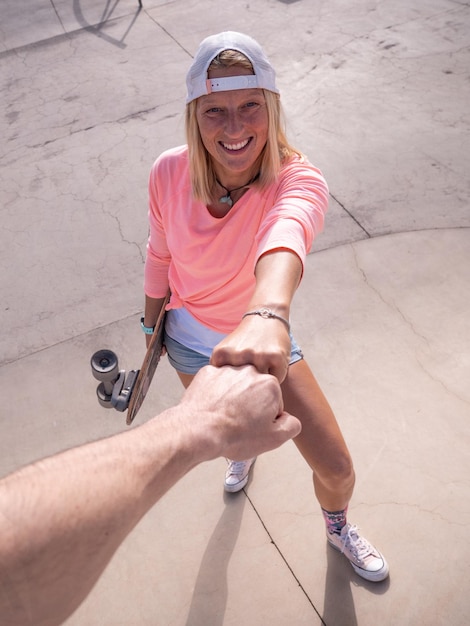 Caucasian skater woman doing fist pound