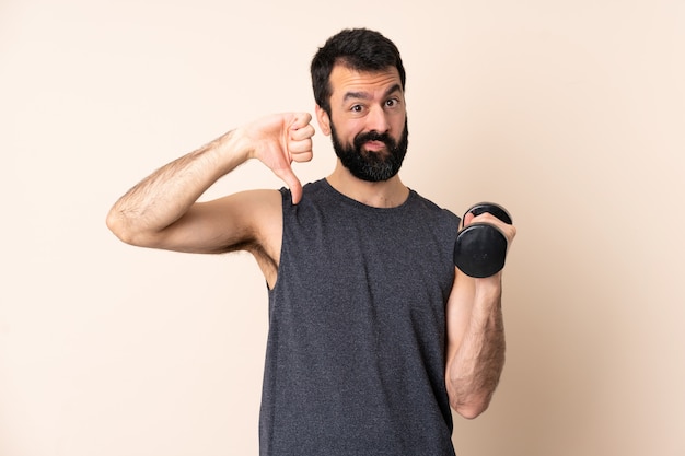 Caucasian sport man with beard making weightlifting over wall