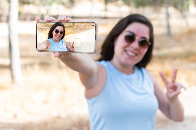 Caucasian student taking selfie portrait in forest