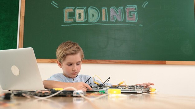Caucasian student working on electronic board while sitting at class Pedagogy