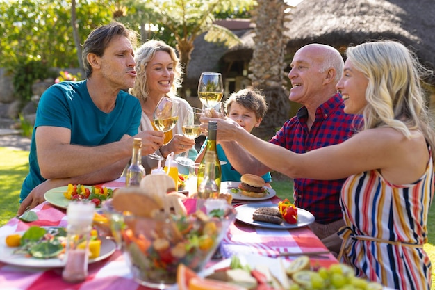 Caucasian three generation family toasting drinks in the garden