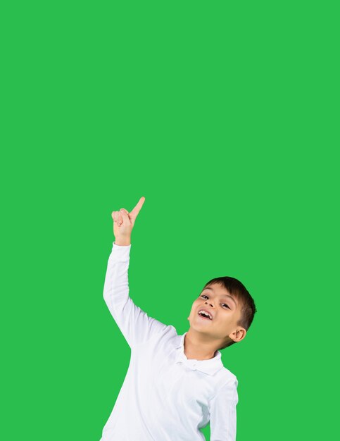 Caucasian toddler boy points up his index finger to an empty space