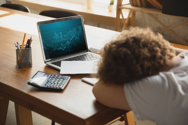 Caucasian upset and despair man watching financial and economical reports