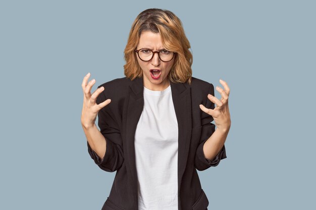 Photo caucasian woman in black business suit screaming with rage