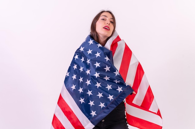 Caucasian woman embracing usa flag isolated on a white background