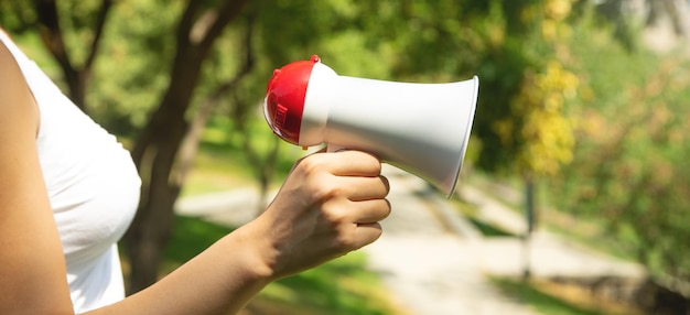 Caucasian woman holding megaphone at outdoor