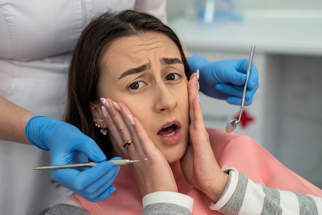 Caucasian woman is having her teeth consult and examined in dental clinic