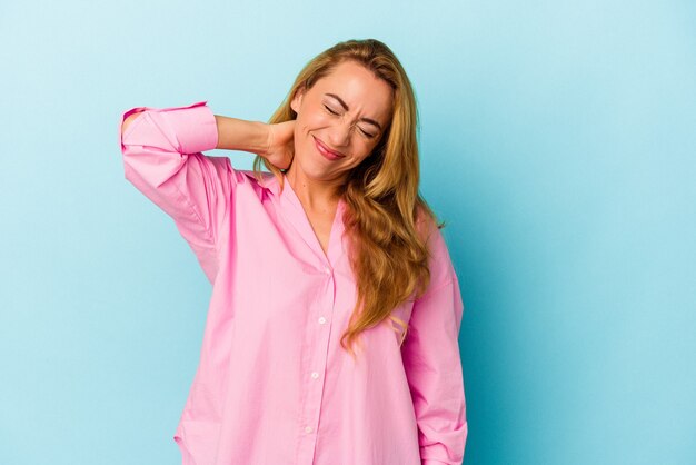 Caucasian woman isolated on blue background suffering neck pain due to sedentary lifestyle