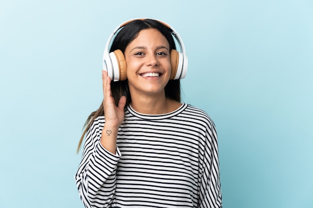 Caucasian woman isolated on blue listening music