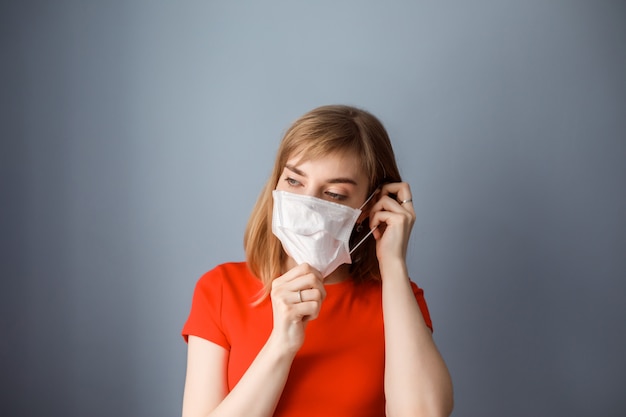 Caucasian woman puts on medical mask. Health care, protecting from covid 19, coronavirus, flu. Protecting health from allergy.