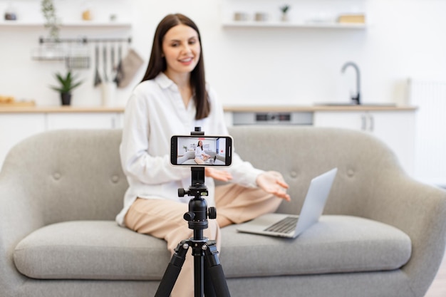 Caucasian woman reading information from modern laptop during live broadcast