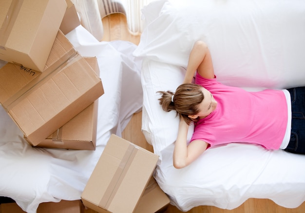 Caucasian woman relaxing between boxes 