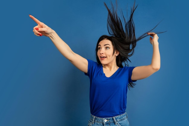 Caucasian woman's portrait isolated on blue studio background