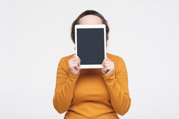 Caucasian woman shows a screen digital tablet