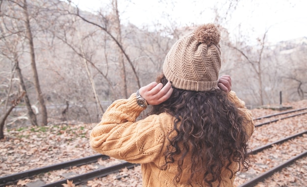 Caucasian woman in trendy hat in autumn park