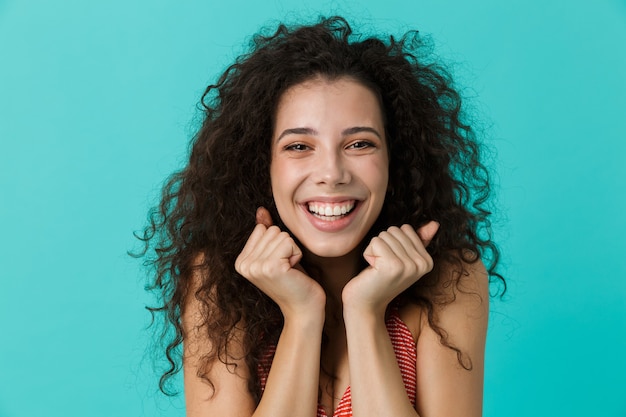 caucasian woman wearing casual clothing laughing, standing isolated over blue wall