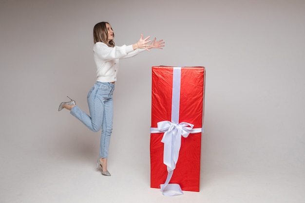 Caucasian woman with attractive appearance rejoices of a big present for st