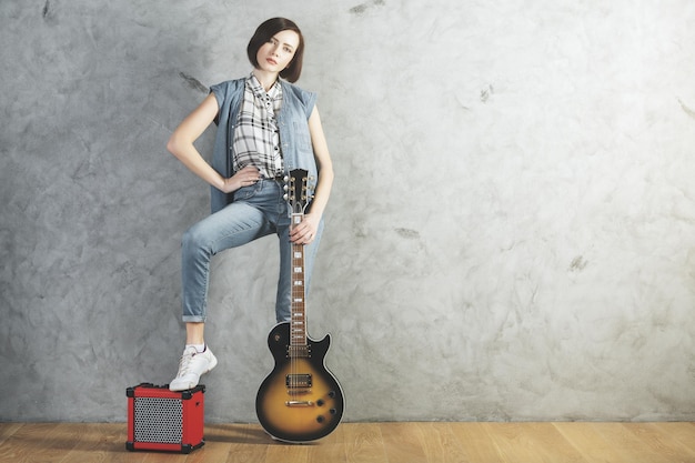 Caucasian woman with guitar in studio