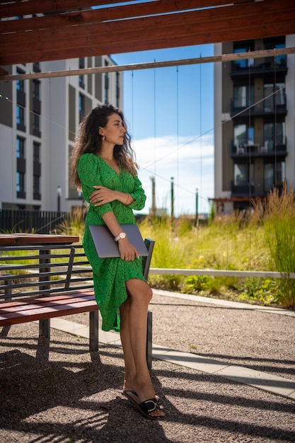 Caucasian woman with laptop computer outside office