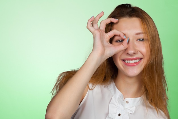 Caucasian woman with ok sign gesture