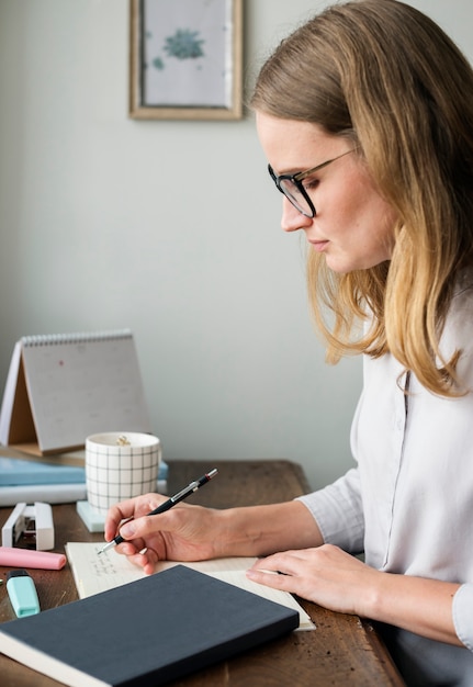 Caucasian woman writing a note