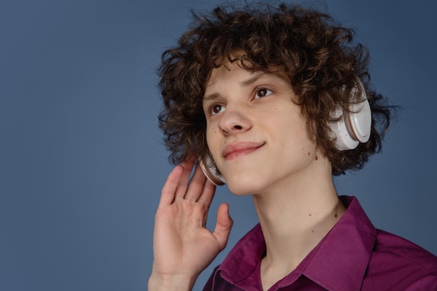 Caucasian young man's portrait isolated on blue studio background with copyspace