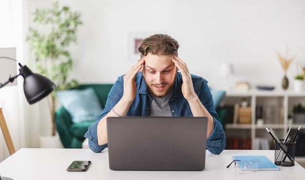 Caucasian young man sitting at desk