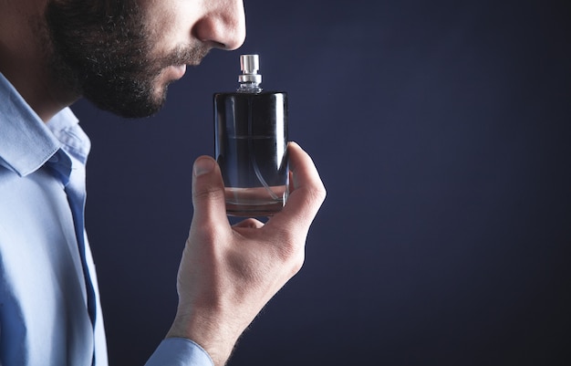 Premium Photo  Caucasian young man smelling perfume.