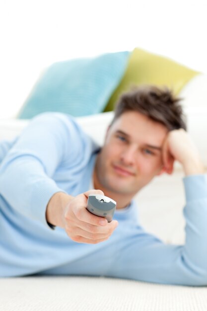 Caucasian young man watching tv in the living-room