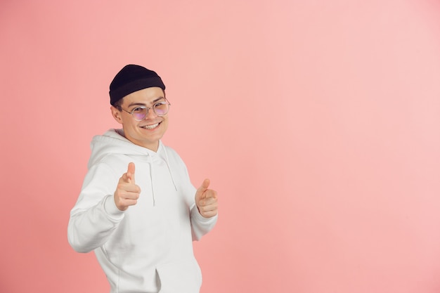 Caucasian young mans modern portrait on pink studio background