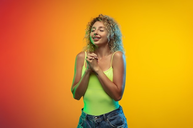 Caucasian young woman portrait on gradient wall