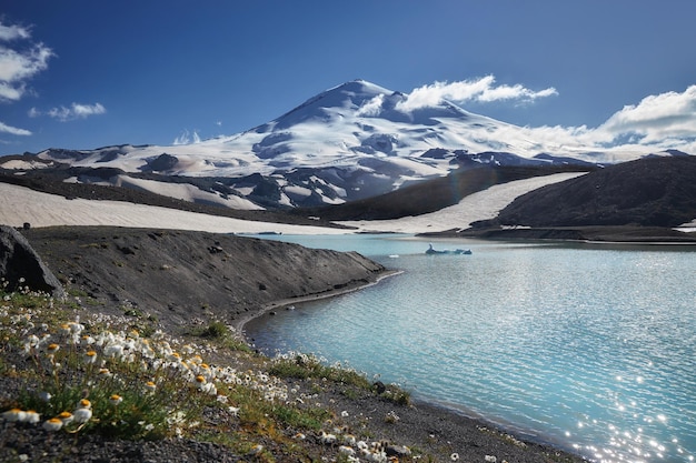 Caucasus Elbrus majestic mountain peak blue sky lake snow covered glacier rocky landscape alpine scenery